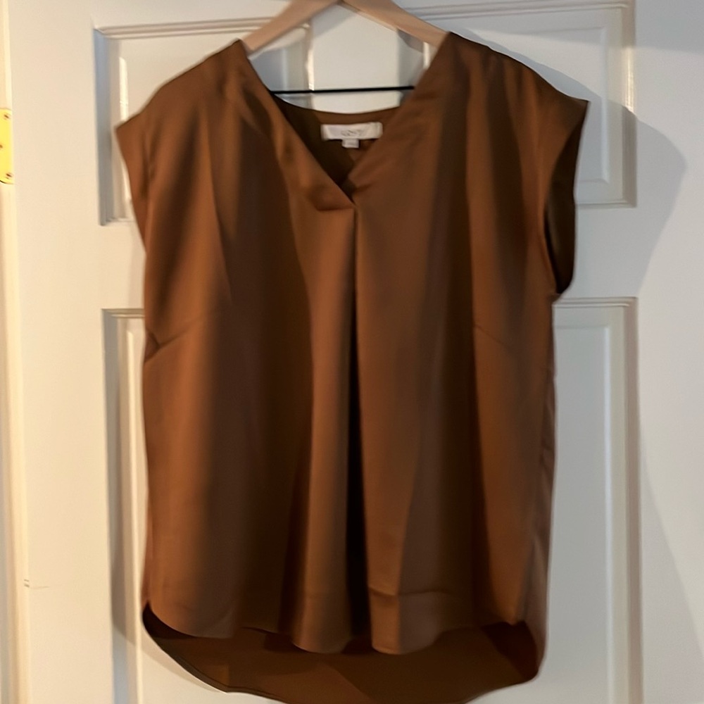 satiny v-neck cap-sleeve blouse. 100% polyester machine wash cold. high-low hem.